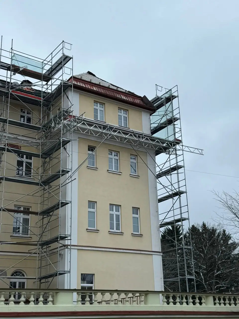 Fasádní lešení na rohové věži historické budovy